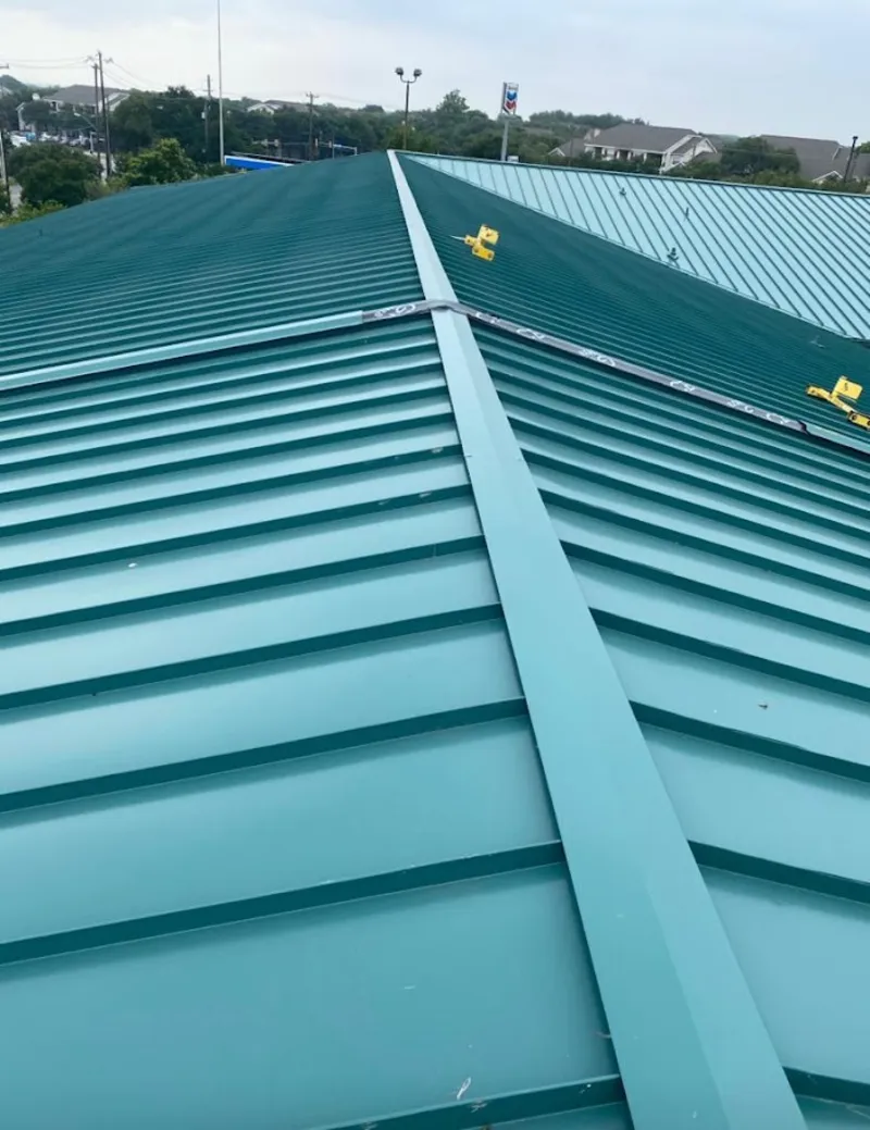 Green commercial metal roof ridge and valley for Metal Roof Repair in Iola